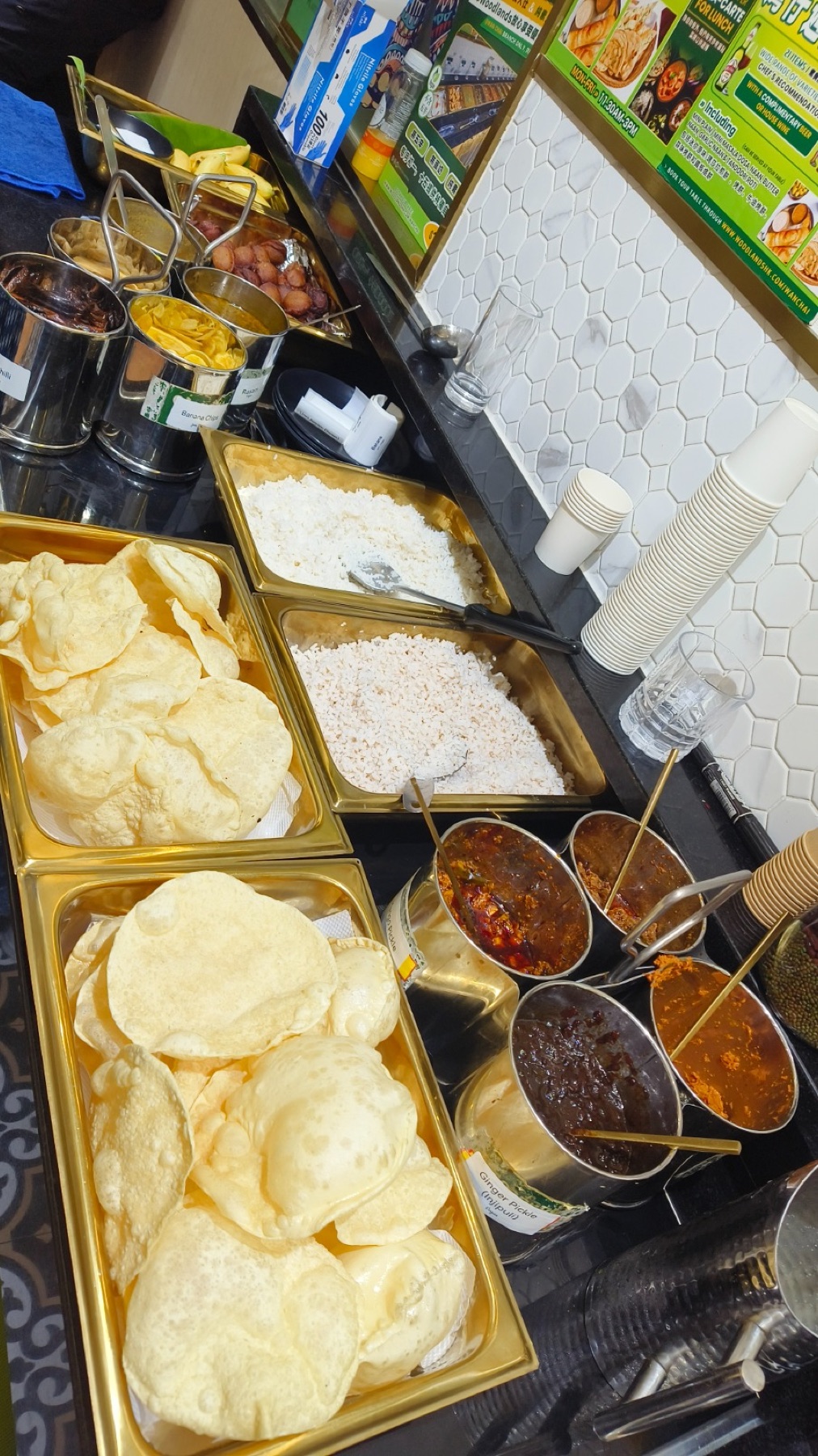Papadam, rice and traditional Kerala pickles laid out for the Sadhya service