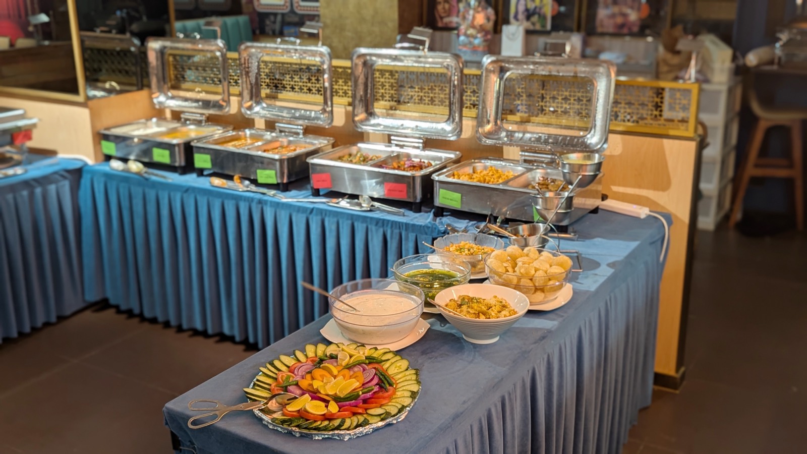 Woodlands Wan Chai buffet line with warmers of Indian curries, pani puri, chutneys and a fresh cut-vegetable salad platter
